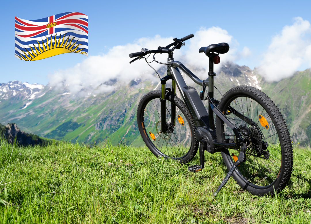 An e-bike on the mountain with a British Columbia flag.